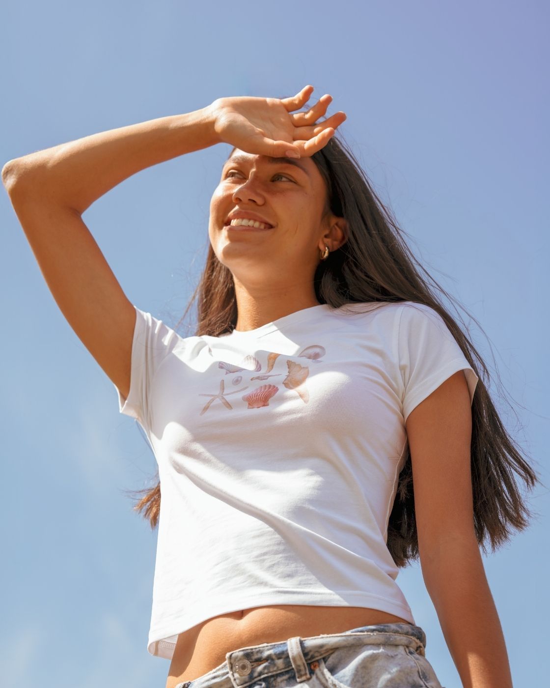 Model wearing the Blaire Shell Print Baby Tee, showcasing the slightly cropped fit and subtle shell design on the front
